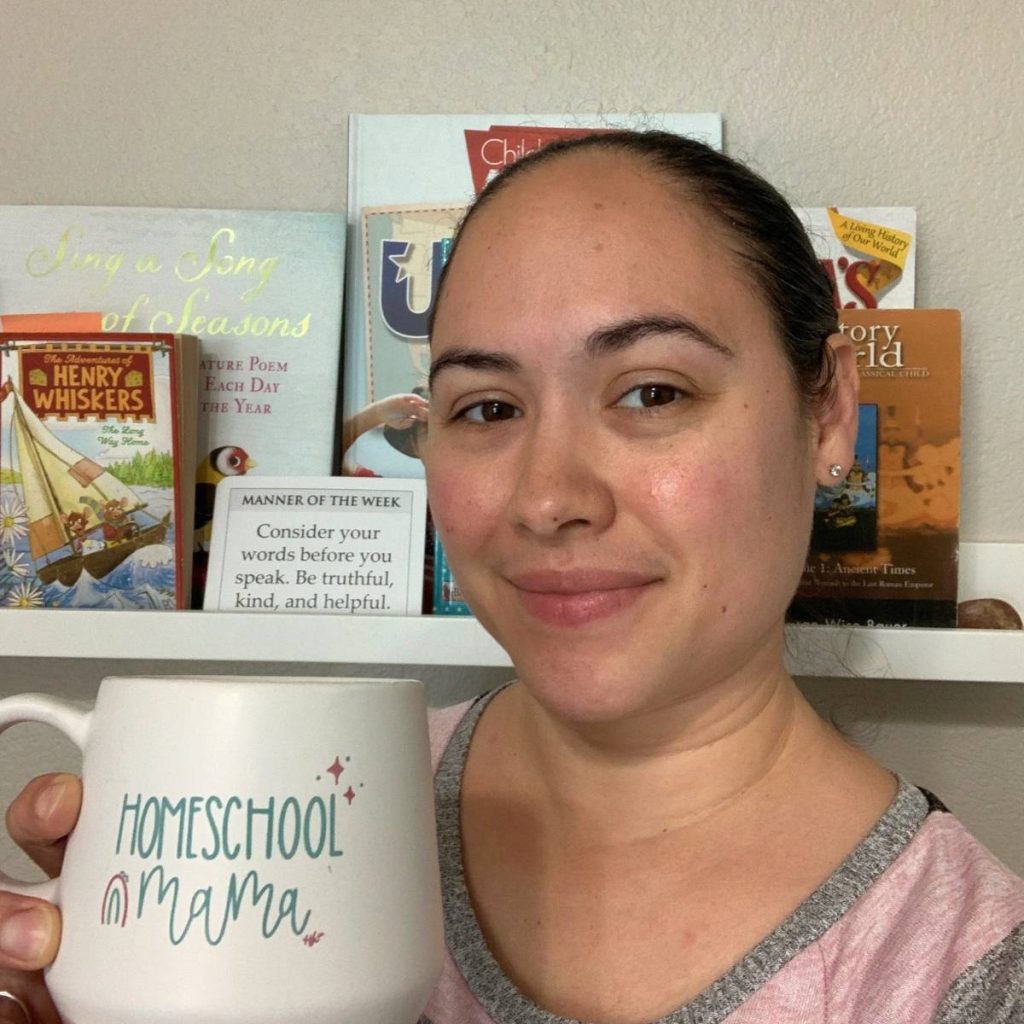 Danielle From Homeschool Freebie's and Giveaways  holding a coffee mug that says Homeschool Mama