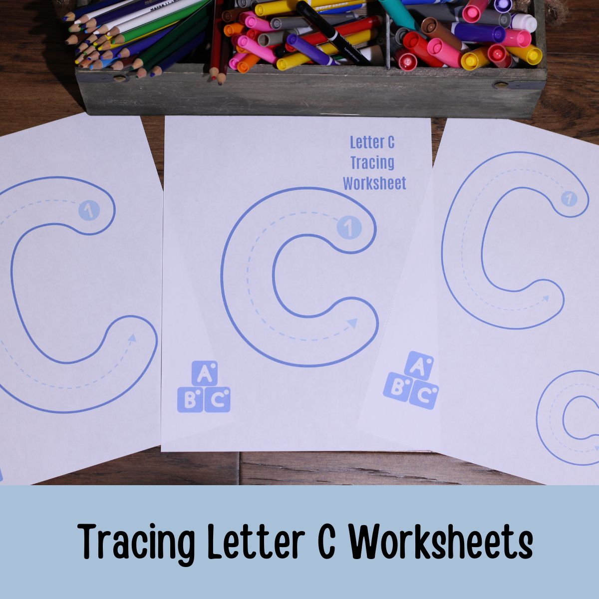 Tracing letter C Worksheets on a table with coloring utencils in the background